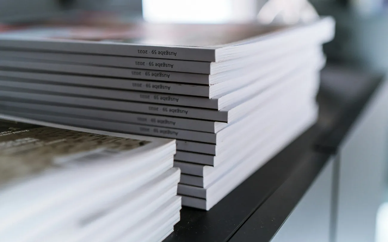 Bound board packs stacked on a dark table