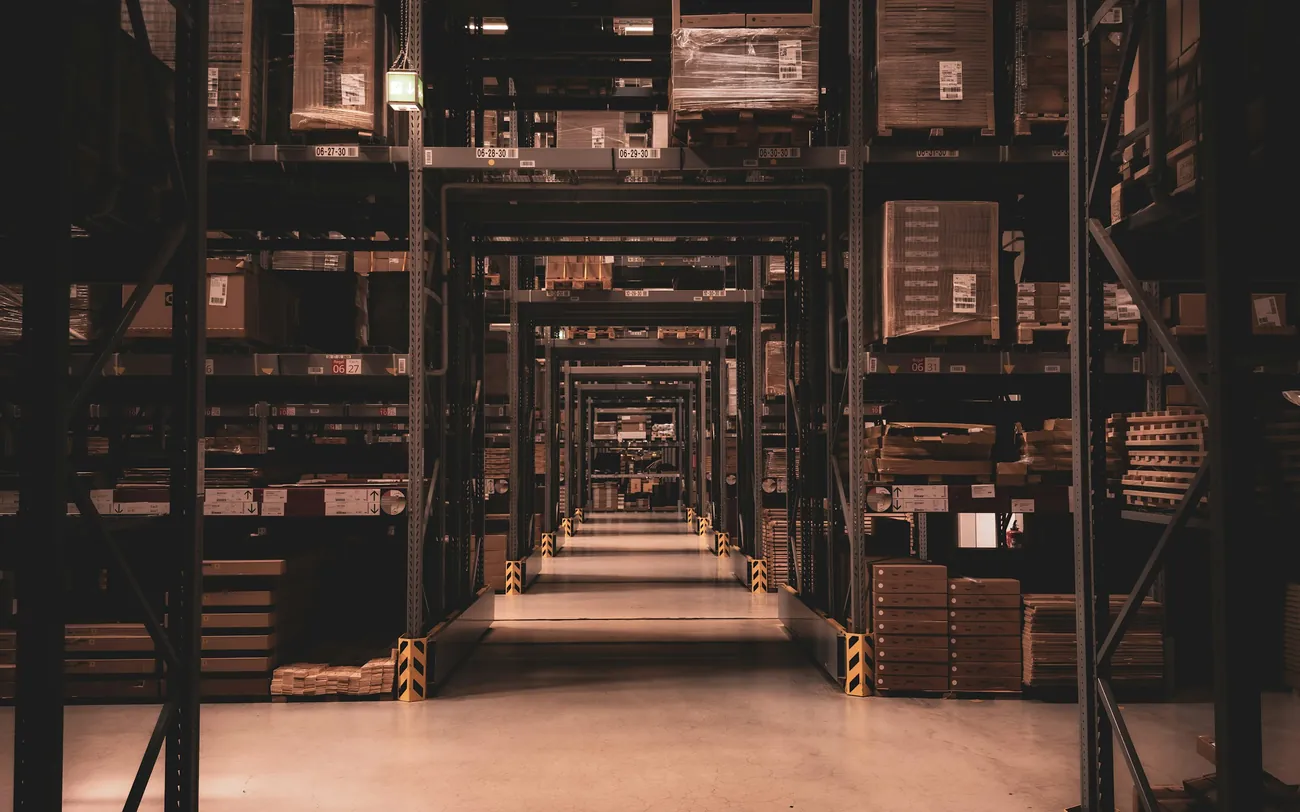 A long warehouse aisle in low light